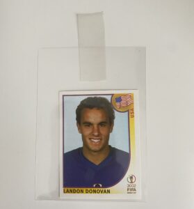 A Landon Donovan soccer card inside a card sleeve with an index tag