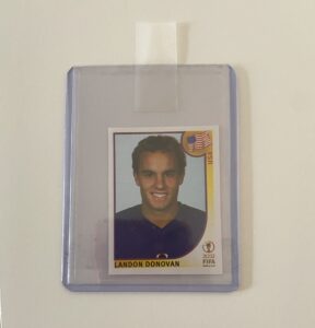 A Landon Donovan soccer card inside a card sleeve and toploader